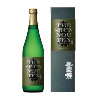 A picture of a green glass sake bottle standing next to a black box that it is sold within. The bottle has a gold foil capsule and a mostly black label with "The Shunnounten" written in English behind Japanese Kanji.