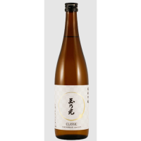 A bottle of Tamano Hikari Classic. Tall brown sake bottle with a white label. There is a gold circle on the label- very classy looking. Tamano Hikari is written down the front of the label in black Kanji.
