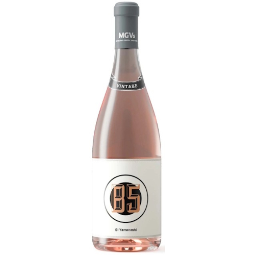 A beautiful bottle of soft pink rose wine made by MGVs. Grapes are muscat bailey A, all grown in Yamanashi. The glass bottle is clear and there is a grey capsule over a cork, with a white label and a black circle that contains the letters B5 in gold.