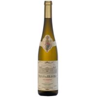 A tall and skinny bottle of white wine from Palacio de brejoeira. The bottle appears golden to dark green in color with off-white, very entique looking labels encrusted with gold foil. The Palace of Brejoeira is illustrated on the label in black ink.