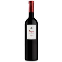 A bordeaux shaped wine bottle of dark glass with a red metallic foil capsule and simple white label that has a black beech tree and the word FAGUS in red lettering.