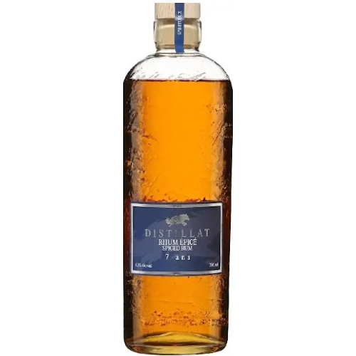 A bottle of rhum in a clear glass motled bottle made with recycled glass. The ocean-blue label has a silver wolf on it and the words Distillat Rhum.
