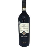 A dark and severe looking bottle of wine with dark glass and a white label that is full of black typeface. The wine is Tinazzi Amarone.