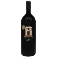 A photograph of a very masculine looking bottle of wine. Broad sholdered glass bordeaux bottle with a label that is shaped like an archway and is called Tinazzi Opera N 3.