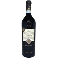 A severe looking bordeaux wine bottle with dark glass and a white label with a bunch of illegible writing on it. You can read, however, Tinazzi Rovertondo Ripasso.