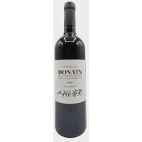 A darnk-glassed bottle of Bordeaux with a while label denoting the name, Chateau les Donats with a flock of birds sitting on a wire under the words.